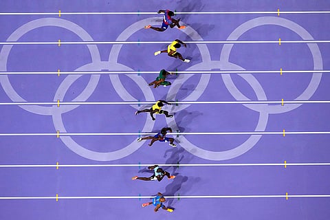 Athletes compete during men's 100-meter final